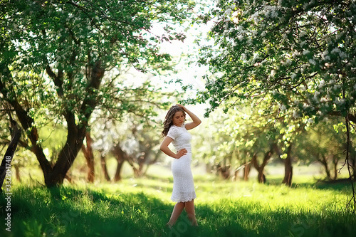 spring girl apple flowers, nature portrait of happy girl with long hair in blooming apple trees, freedom purity concept of happiness © kichigin19