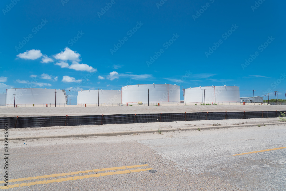 Fuel storage tanks with stairs under blue sky at the roadside in Corpus Christi, Texas, America