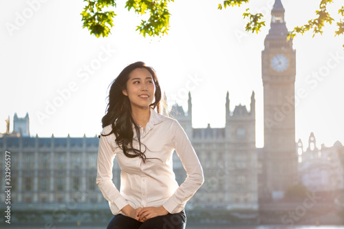 Asian business women near Big Ben, London, England. Girl in London during winter near Westminster bridge, London. oung female travel  in London, England. Beautiful young Asian girl. 