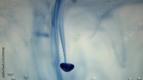 Blue ink sliding down the water photo