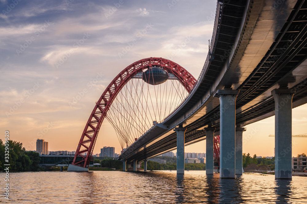 Obraz premium Sunset view of Picturesque bridge with big red arch over the Moscow river, Moscow, Russian Federation.