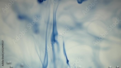 Blue ink sliding down the water photo