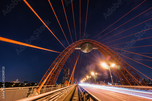 Sunset view of Picturesque bridge with big red arch over the Moscow river, Moscow, Russian Federation. © Neonyn