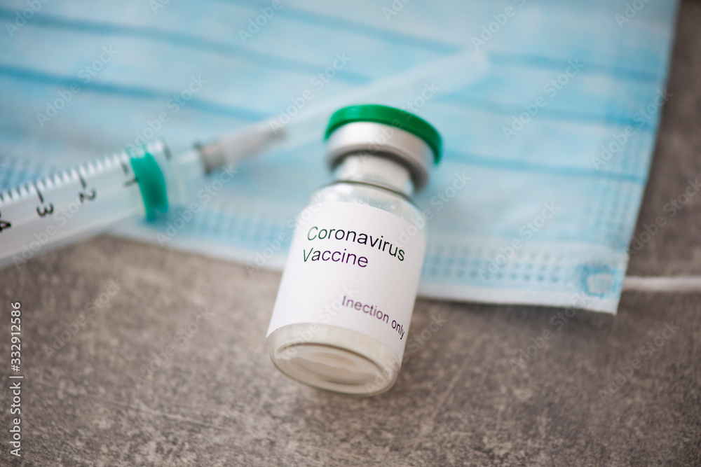 Medical mask and syringe and needles a Coronavirus infection and protection concept Medical mask and syringe and needles a Coronavirus infection and protection concept
