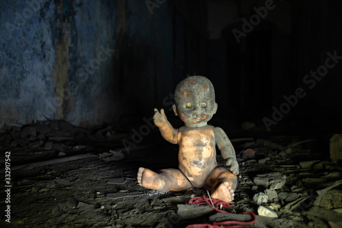 Fotografie scary doll in the ruins of an abandoned bunker
