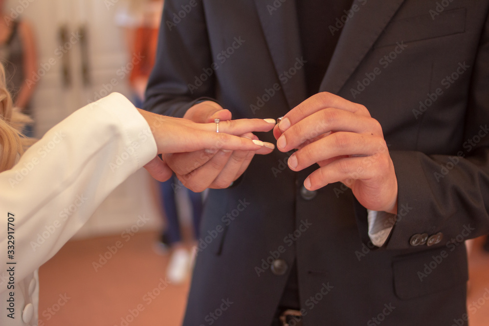 groom putting a ring on brides finger groom putting a ring on brides finger