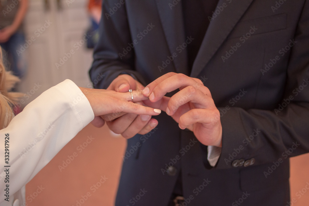 Fototapeta premium wedding rings in hands of newlyweds