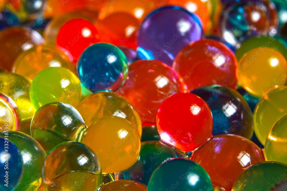 background of multi-colored, blurry, wet hydrogel balls background of multi-colored, blurry, wet hydrogel balls