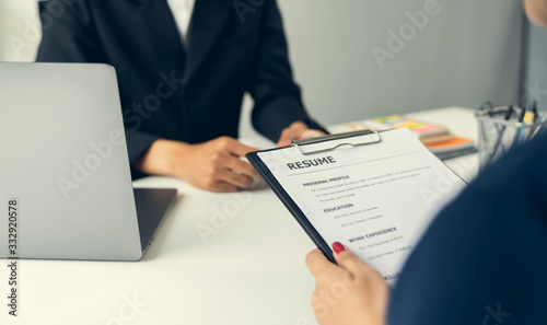 Young woman submit resume for a job interview in office. Quality employment concepts.