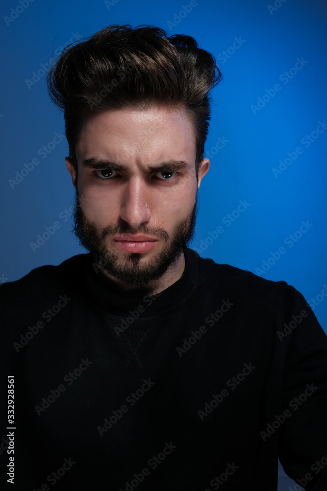 Beautiful caucasian young man portrait isolated on multicolored neon light backgroud. Young, smiling, surprised, screaming. Human emotions, facial expression concept. Trendy colors.Advertising concept