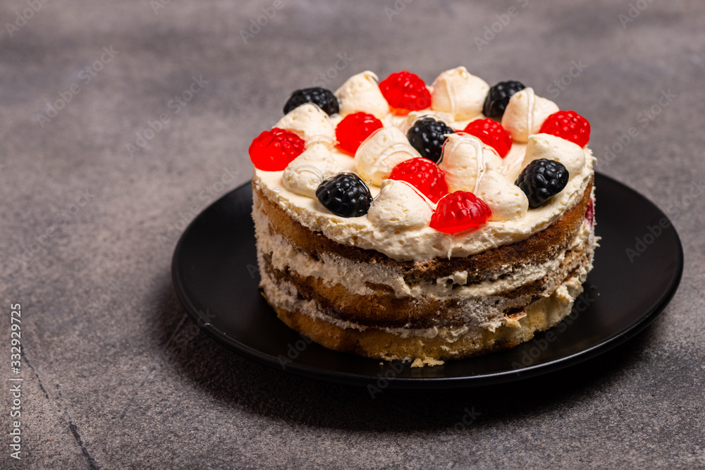 Cake with mascarpone cream on a gray noble background.