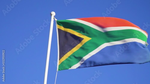 South African Flag Waving in the Wind under Blue Sky in Slow Motion