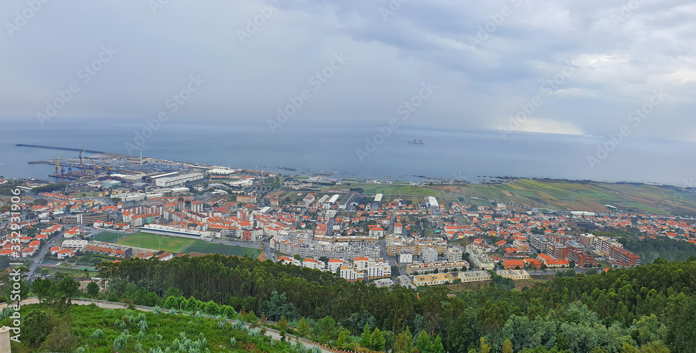 Top view from the hill of city and sea coast