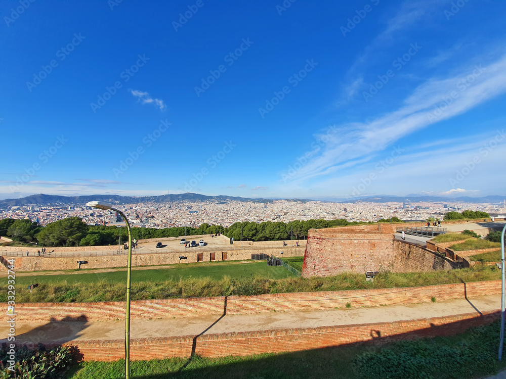 Ancient fortification walls and Barcelona panorama