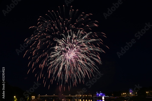 Salute on city day in Tver on the background of the bridge over the Volga river