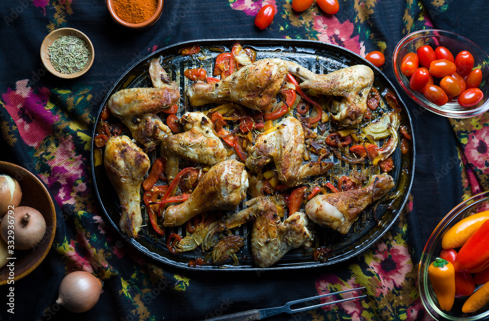 Roasted chicken leg with vegetables and spices.