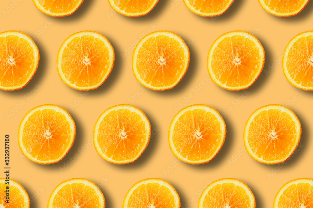 summer pattern with juicy ripe fresh orange on a yellow background summer pattern with juicy ripe fresh orange on a yellow background