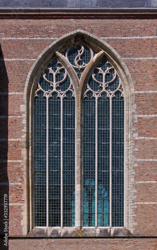 Pointed ogive arch with gothic window at the brick facade of Brouwershaven city church in the Netherlands photo