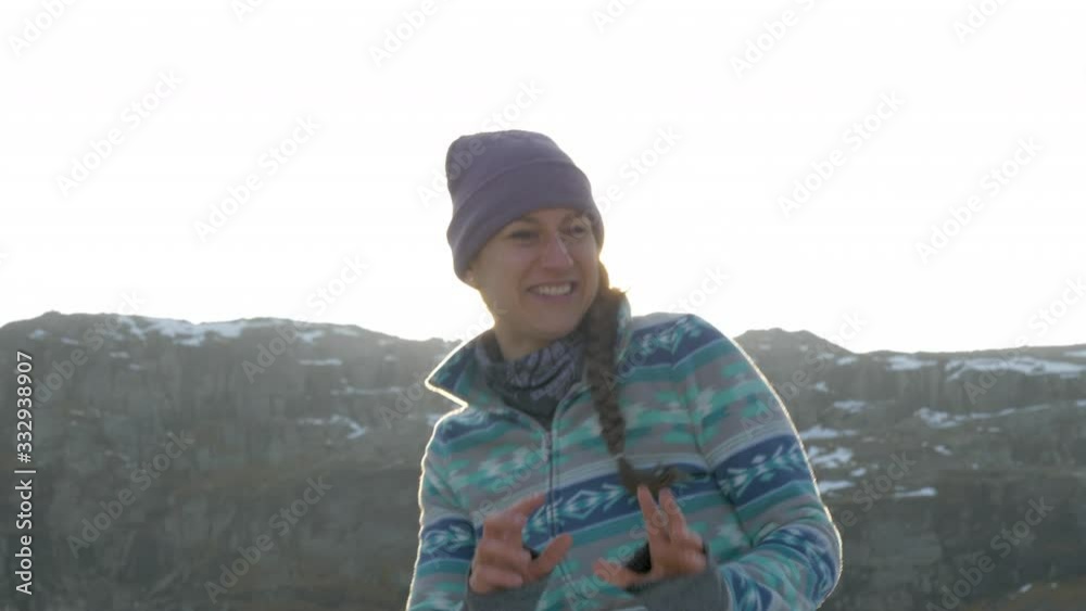 A Woman in a Snowball Fight During Sunset on top of a Mountain in Norway, Slow Motion