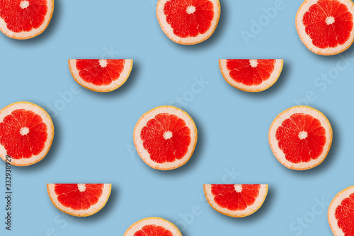 Fototapeta Naklejka Na Ścianę i Meble -  summer pattern with red juicy ripe fresh grapefruit on a blue background
