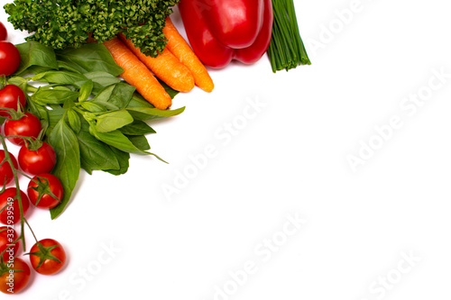 Fresh vegetables on a white background. Tomatoes, carrots, greens