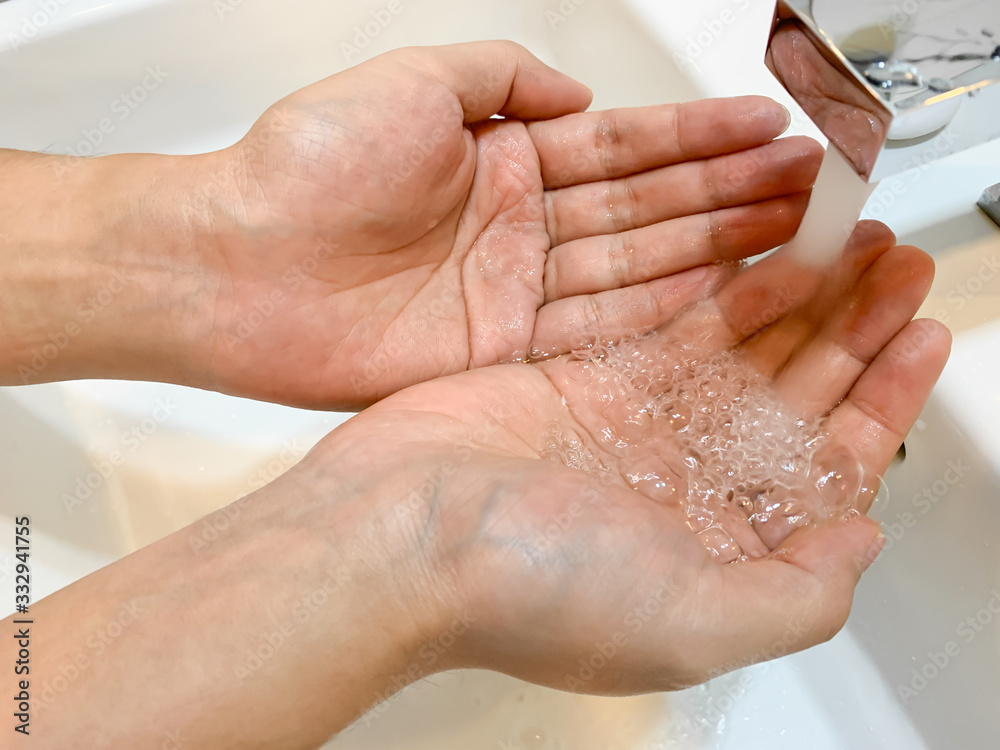 Washing hand with water under the faucet, without soap, hygiene concept, washing hand for prevention of corona virus Washing hand with water under the faucet, without soap, hygiene concept, washing hand for prevention of corona virus