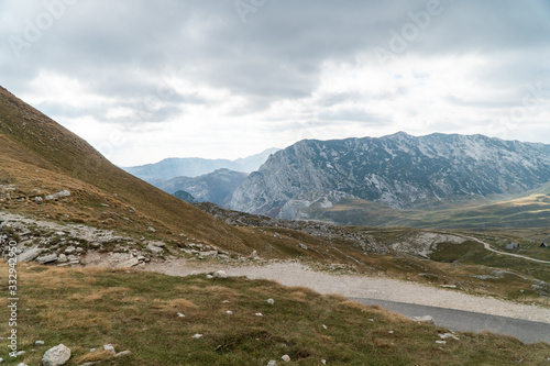 Scenic view of the mountains. Mountain road meanders between the hills. Background