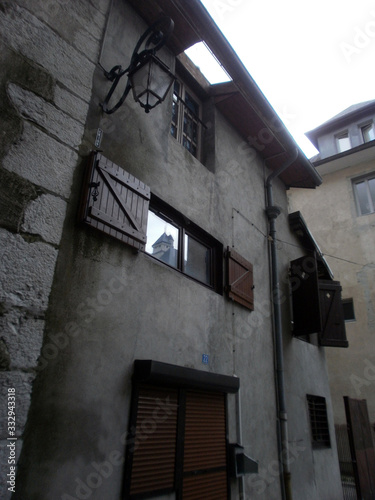 Chambéry, France - August 5th 2011 : Focus on very old facades of a medieval court, in the city center. There's a hole in the roof to bring light to the top flat. photo