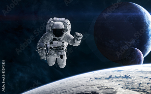 Fototapeta Naklejka Na Ścianę i Meble -  Astronaut on the background of planets in deep space. Science fiction. Elements of this image furnished by NASA