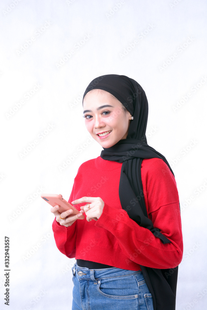 portrait of beautiful woman wearing hijab browsing internet on mobile phone isolated on white background portrait of beautiful woman wearing hijab browsing internet on mobile phone isolated on white background