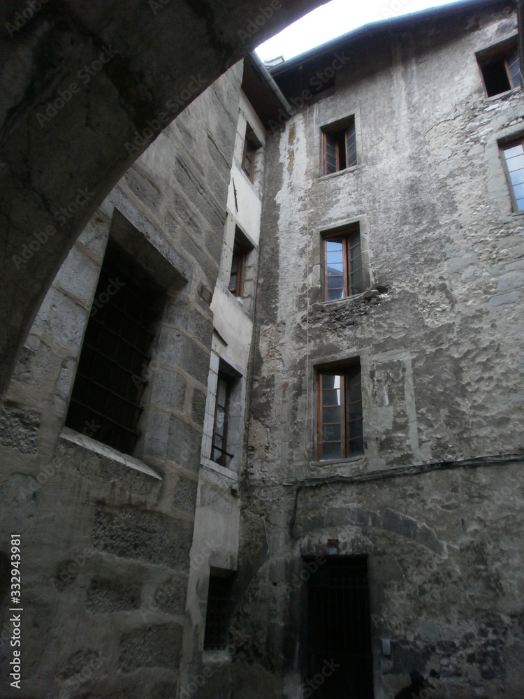 Chambéry, France - August 5th 2011 : Focus on very old facades of a medieval court, in the city center.