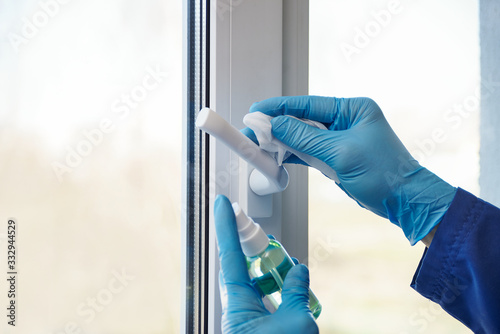 sanitizer disinfection of handles on windows and doors in rooms.