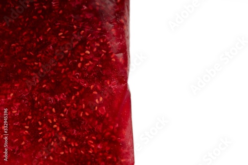 Frame for text from raspberry jam. Appetizing jelly of bright scarlet cranberry, cherry, redcurrant.Dark red berry jam blot frame or spot isolated on white background. Sweet confiture drops or marmala photo