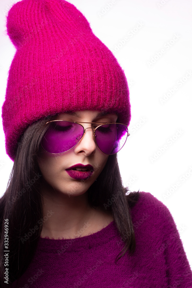 a girl in a purple sweater, purple glasses with purple lipstick on her lips and a pink hat a girl in a purple sweater, purple glasses with purple lipstick on her lips and a pink hat
