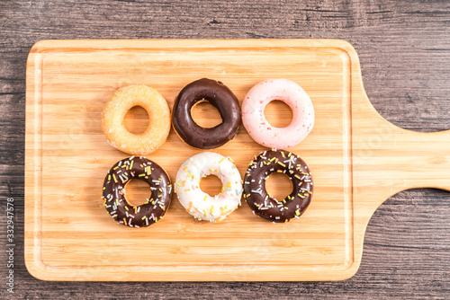 Donuts and coffee on wooden table.