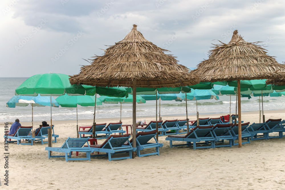 Tourists lying on sunbeds in China Beach in Da Nang