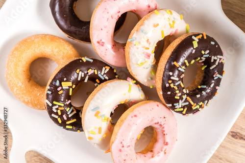 Donuts and coffee on wooden table.