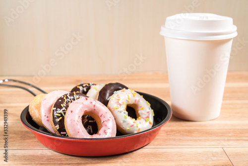 Donuts and drink and iron frying panon wood table background top view copy space pattern photo