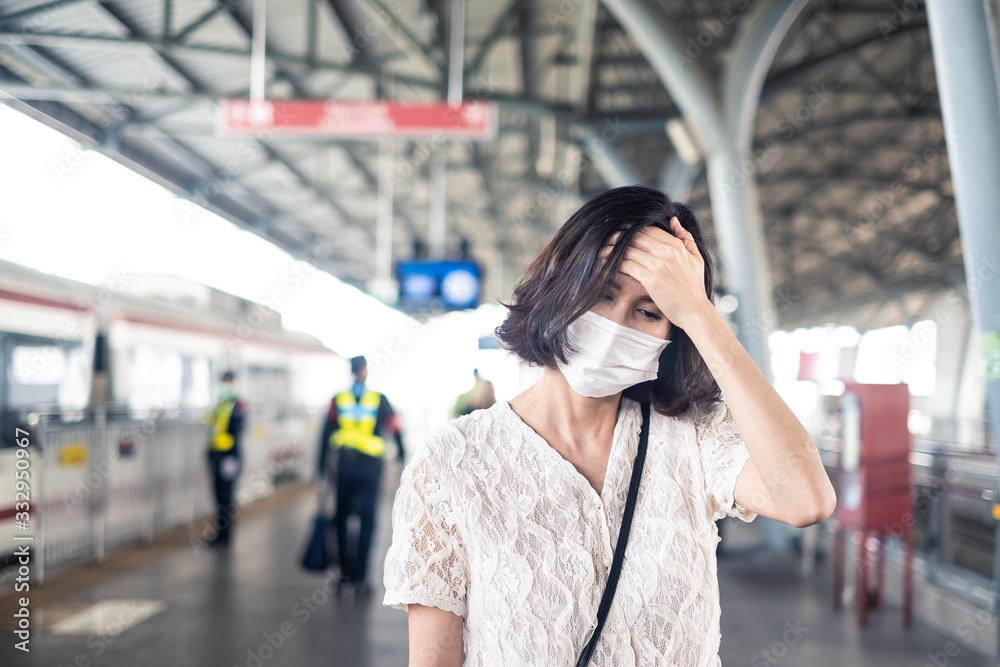 Asian woman wearing mask for prevent dusk pm 2.5 bad air pollution and coronavirus or covid-19 spreading over Asia. Girl wearing mask and having a cough due to bad smell and allergic symptom on train. Asian woman wearing mask for prevent dusk pm 2.5 bad air pollution and coronavirus or covid-19 spreading over Asia. Girl wearing mask and having a cough due to bad smell and allergic symptom on train.