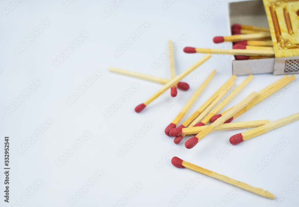 Close up picture of some flammable red fire matches scattered beside a small match box Close up picture of some flammable red fire matches scattered beside a small match box