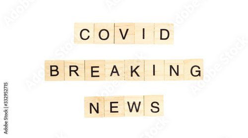 The words `Covid Breaking News` spelt out with letter tiles on the white background