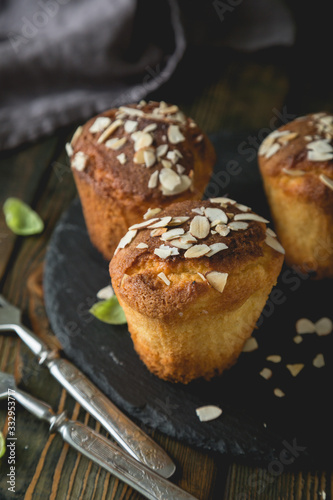 Fresh muffins with marzipan and almonds