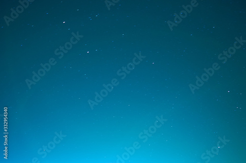 Black night sky plenty of stars. Abstract gradient night blue sky with stars. © Oleg Picolli