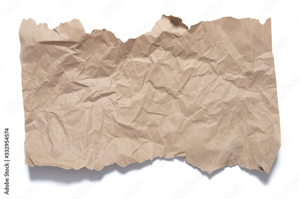 Fragment brown paper with torn edges and crumple traces. Object on white background with shadow Fragment brown paper with torn edges and crumple traces. Object on white background with shadow