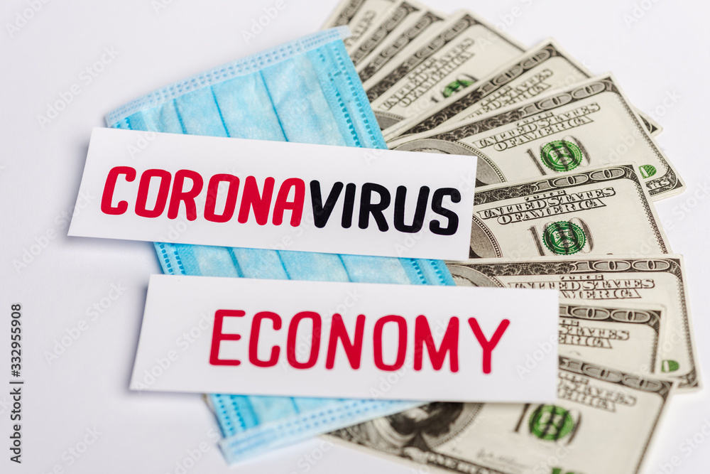 dollar banknotes, medical mask and coronavirus and economy cards on white background dollar banknotes, medical mask and coronavirus and economy cards on white background