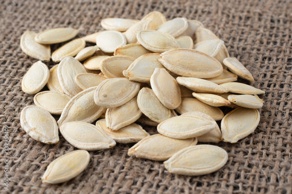 Fresh pumpkin seeds on burlap. Autumn vegetables. Fresh pumpkin seeds on burlap. Autumn vegetables.