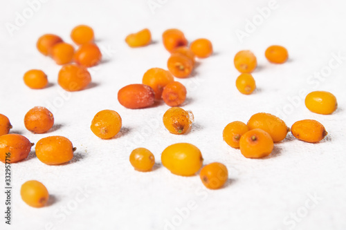 Organic frozen sea buckthorn berries on gray background