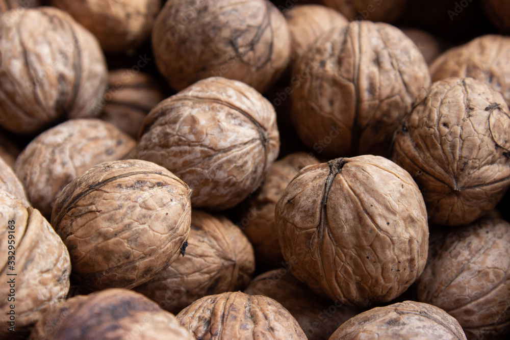 Walnuts in shell .Inshell walnuts close-up. Brown walnuts. Walnuts in shell .Inshell walnuts close-up. Brown walnuts.