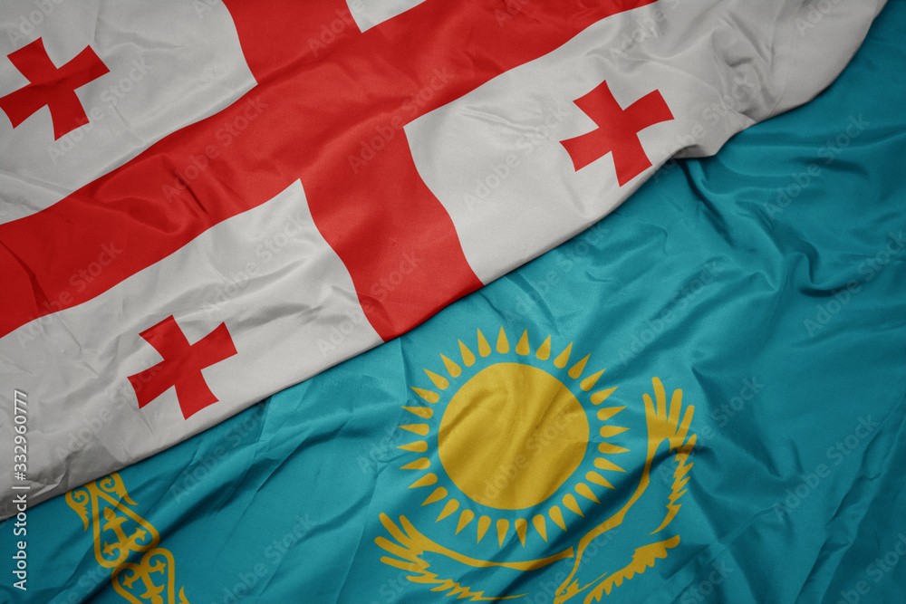 Fototapeta premium waving colorful flag of kazakhstan and national flag of georgia.