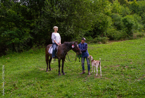 man and woman go horse riding